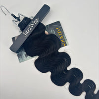 Close-up of the wave pattern on a JAZZWIGS Raw Vietnamese body wave hair bundle beneath a branded clip.