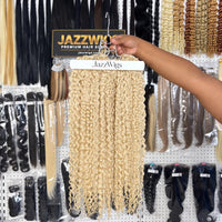 JAZZWIGS #613 Blonde Burmese Curly Feather Crochet Human Hair, multiple hair groups displayed on a hanger in the showroom