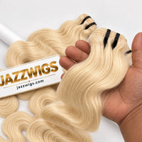 Hand-held close-up of #613 blonde raw Body Wave hair