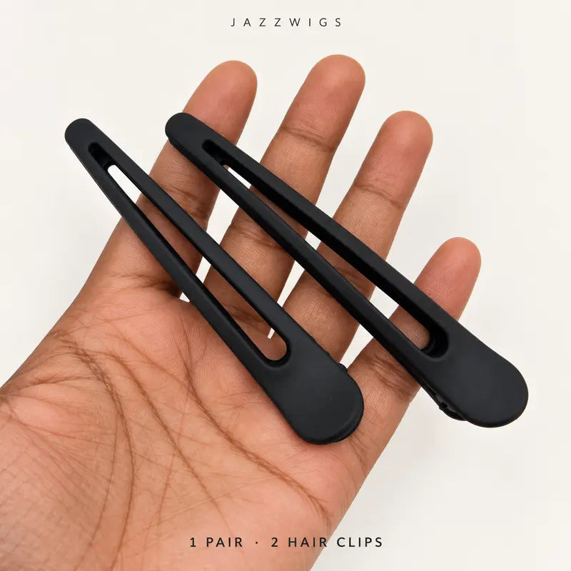One pair of two black hair clips shown on a hand