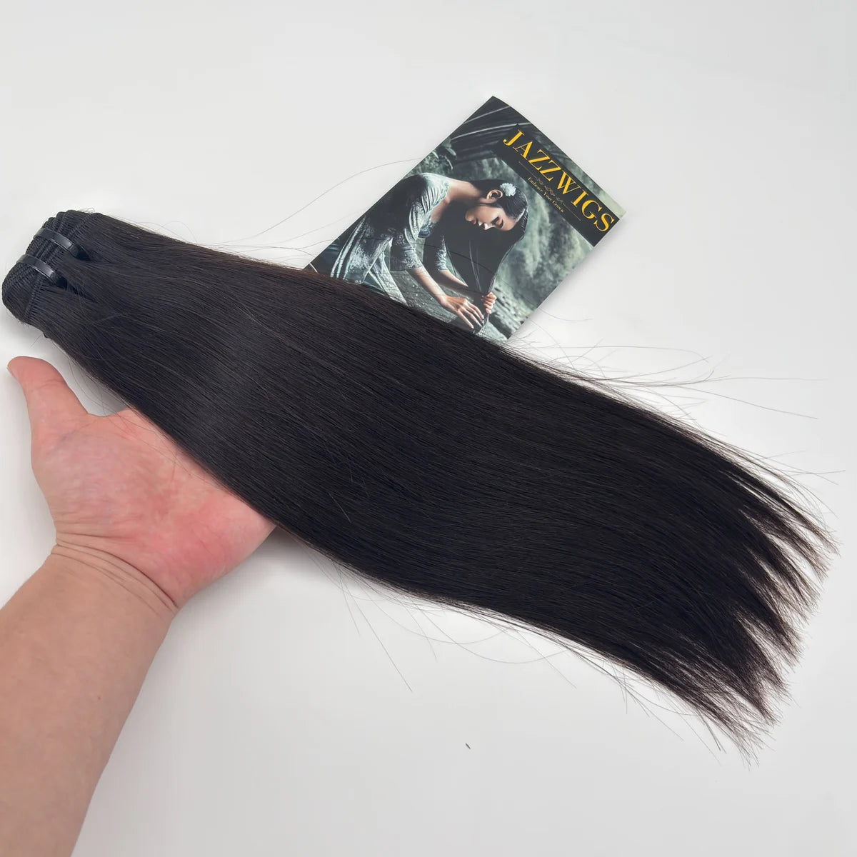 Raw Vietnamese Straight Hair 1 Bundle held by hand to show density, smooth texture and natural black color.