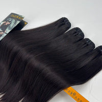 Close-up of JazzWigs Raw Vietnamese Straight Hair 4 Bundle Deal showing bundle wefts, machine-sewn tracks, branded card and measuring ruler.