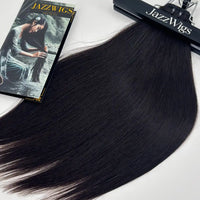 Raw Vietnamese Straight Hair weft top close-up showing machine-sewn bundle construction and natural black human hair.
