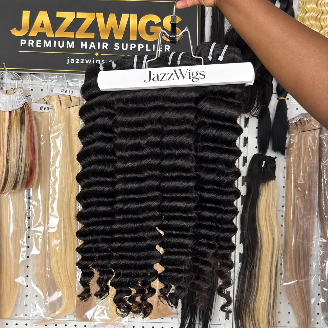 JAZZWIGS Virgin Cambodian Deep Wave human hair in natural black #1B, multiple bundles displayed on a hanger.