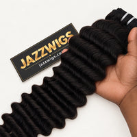 JAZZWIGS Virgin Cambodian Deep Wave human hair in natural black #1B, handheld view of a hair bundle.