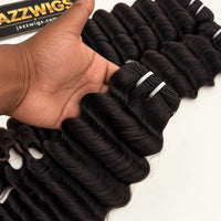 JAZZWIGS Virgin Cambodian Deep Wave human hair in natural black #1B, handheld close-up of the weft and waves.