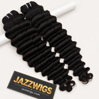 JAZZWIGS Virgin Cambodian Deep Wave human hair in natural black #1B, two bundles displayed over a white support.