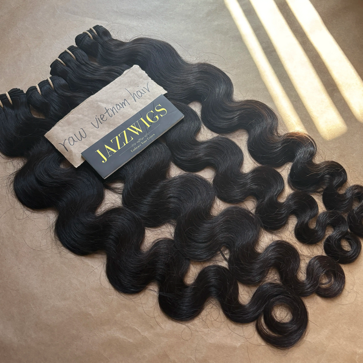 Full volume and soft waves with raw body wave bundles and 5x5 HD lace closure.