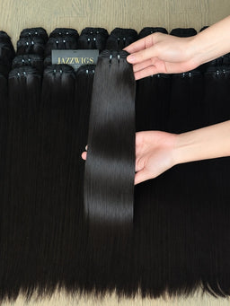 Raw Vietnamese straight human hair bundles wholesale displayed with one single bundle held by hand, silky natural black hair extensions by JazzWigs.