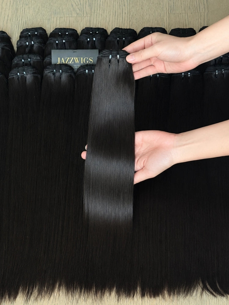 Raw Vietnamese straight human hair bundles wholesale displayed with one single bundle held by hand, silky natural black hair extensions by JazzWigs.