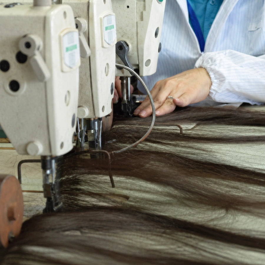 Three-head weft machines sew the hair into strong, secure wefts designed for durable human hair bundles.