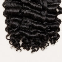 Curly human hair bundle texture detail.