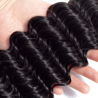 Natural black deep wave human hair bundles for sew-in installs and wig making.